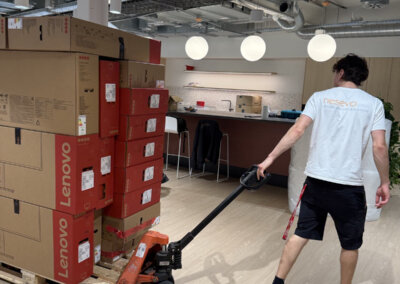nesevo technician moving a pallet of Lenovo monitors with a pallet truck