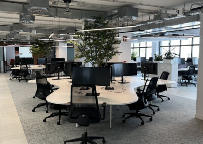 Open-plan workspace after the office IT rollout in Barcelona, with Lenovo workstations at every desk