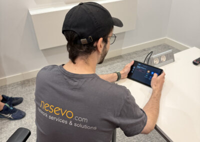 nesevo technician configuring a meeting room touch panel